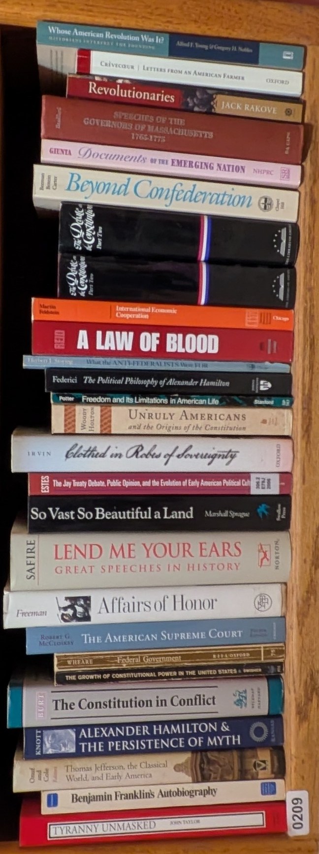 Books on Shelf 209, shown sideways to include the entire shelf