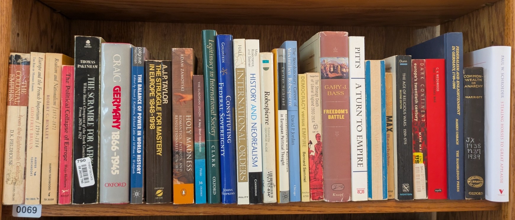 Photograph of Shelf 69; books are listed in top-to-bottom order alongside the photograph.