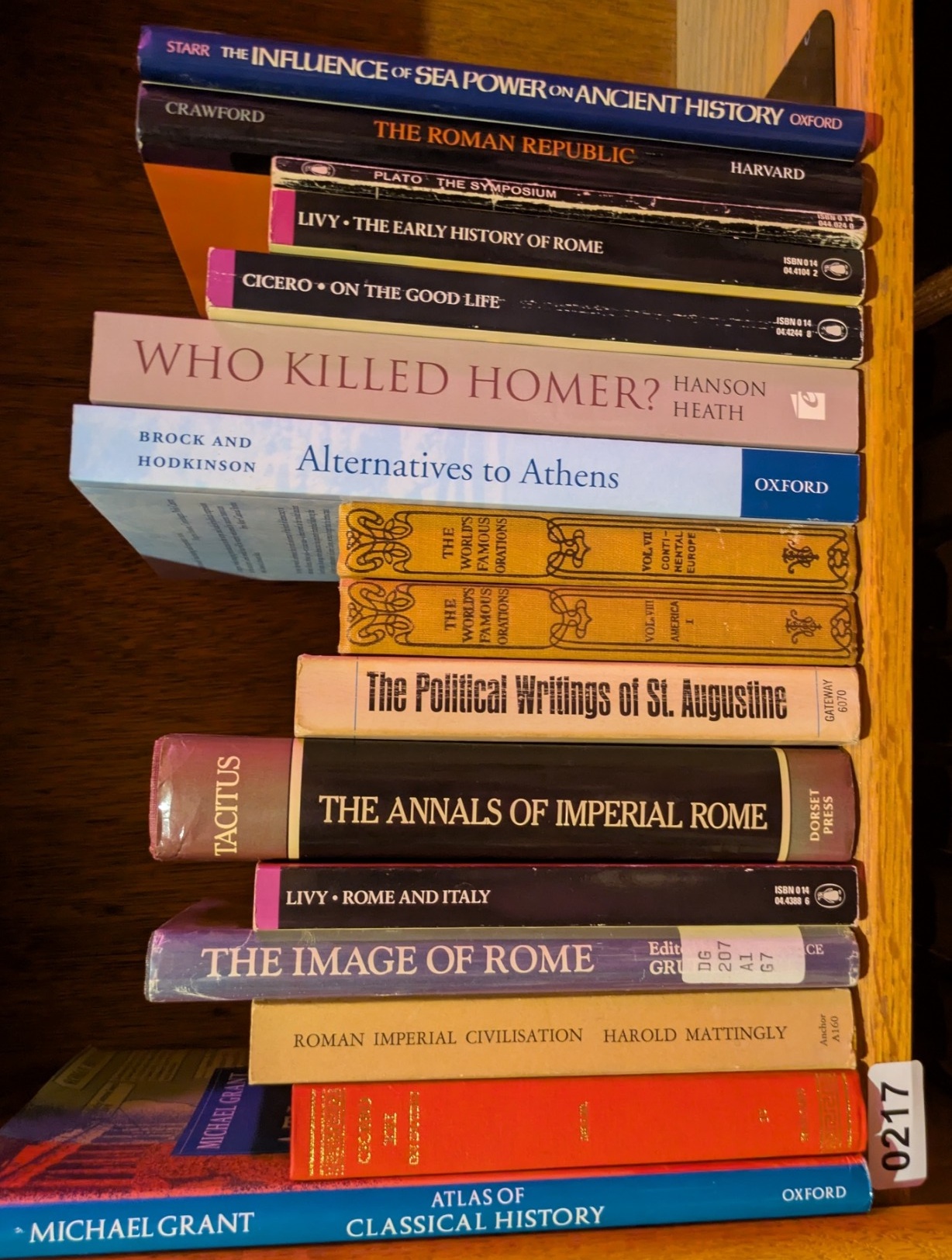 Photograph of Shelf 217; books are listed in top-to-bottom order alongside the photograph.