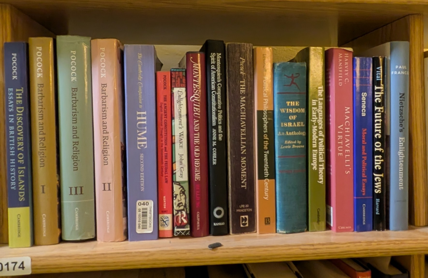Photograph of Shelf 174 with readable book spines.