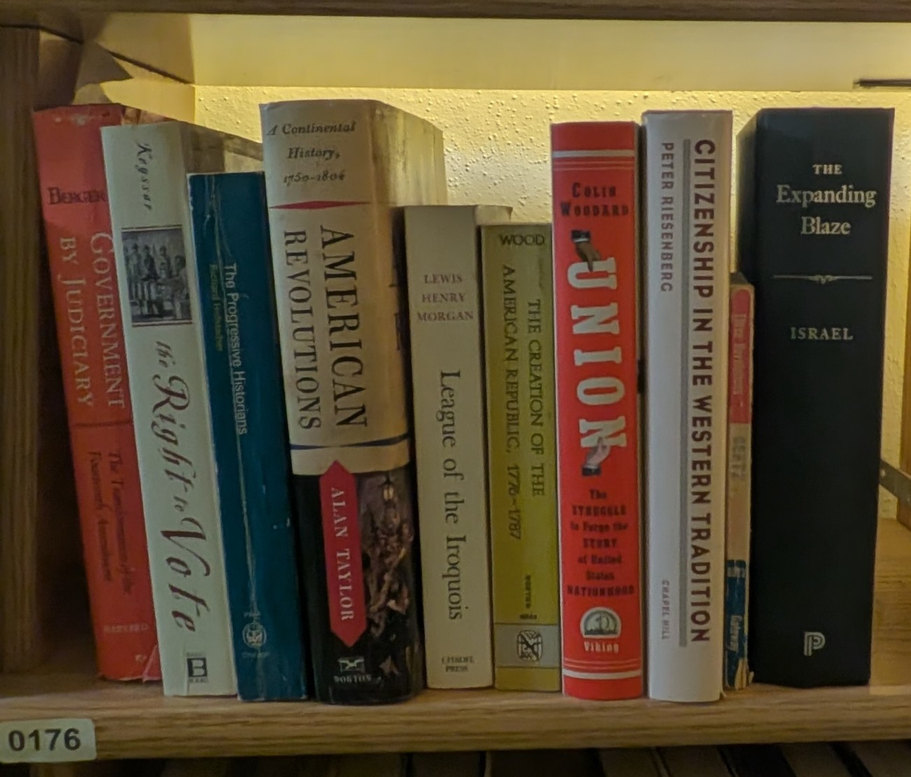 Photograph of Shelf 176 with readable book spines.