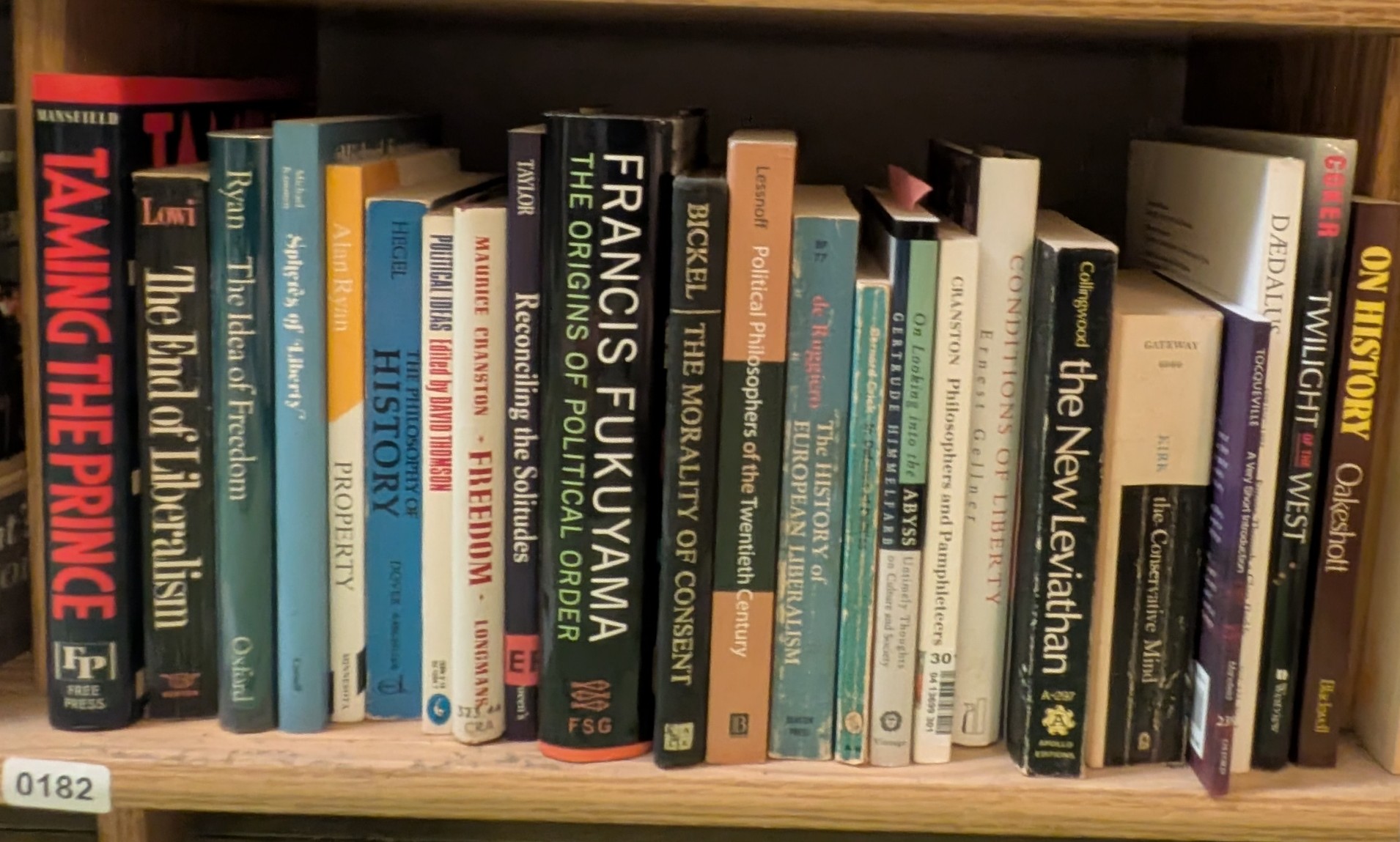 Photograph of Shelf 182 with readable book spines.
