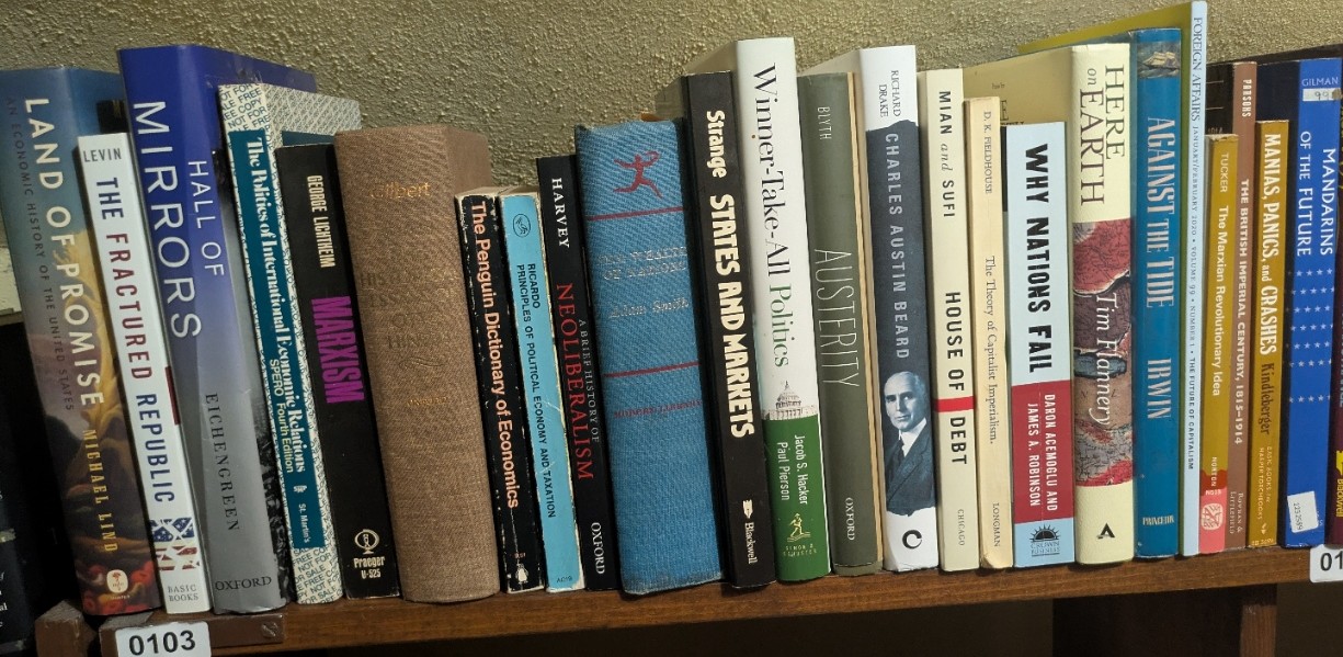 Photograph of Shelf 103; books are listed in top-to-bottom order alongside the photograph.