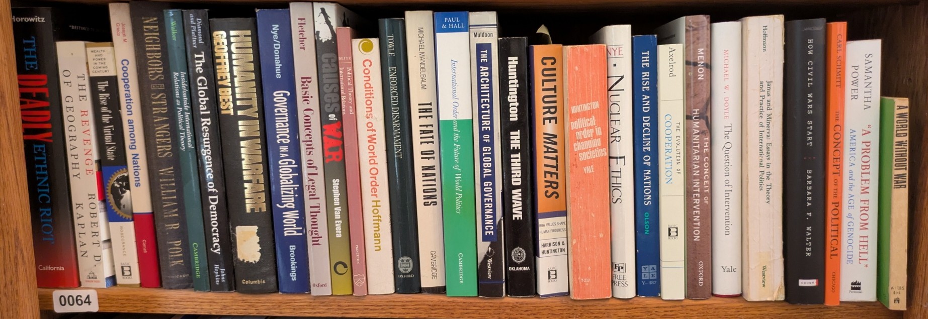 Photograph of Shelf 64; books are listed in top-to-bottom order alongside the photograph.
