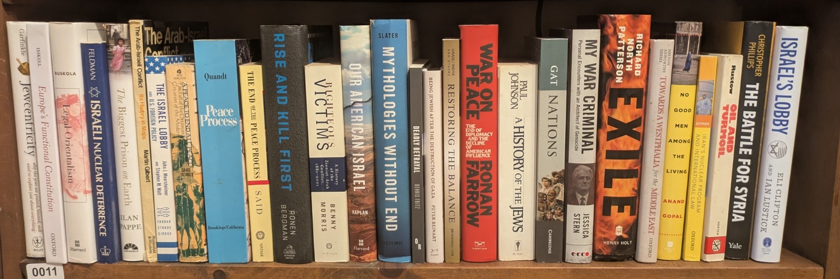 Photograph of Shelf 11; books are listed in top-to-bottom order alongside the photograph.