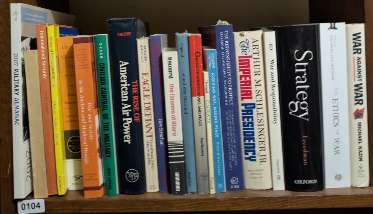 Photograph of Shelf 104; books are listed in top-to-bottom order alongside the photograph.