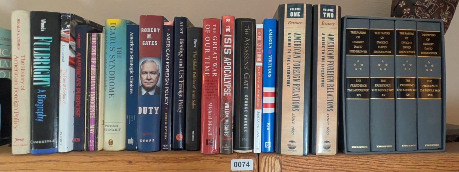 Photograph of Shelf 74; books are listed in top-to-bottom order alongside the photograph.