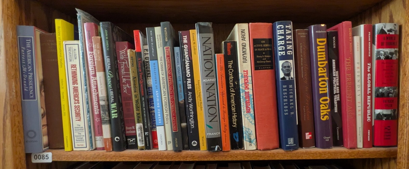 Photograph of Shelf 85; books are listed in top-to-bottom order alongside the photograph.