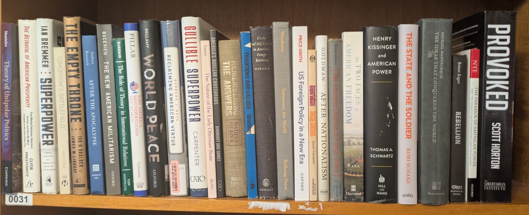 Photograph of Shelf 31; books are listed in top-to-bottom order alongside the photograph.