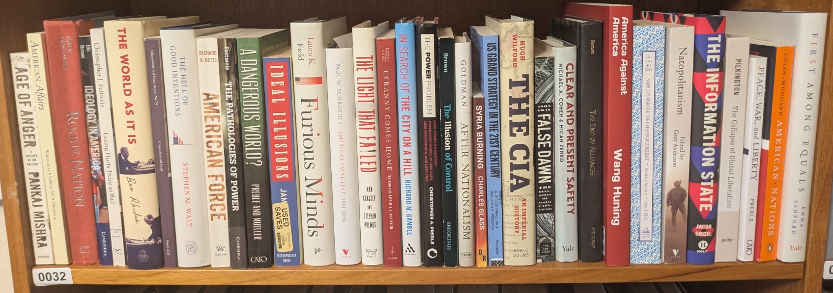 Photograph of Shelf 32; books are listed in top-to-bottom order alongside the photograph.