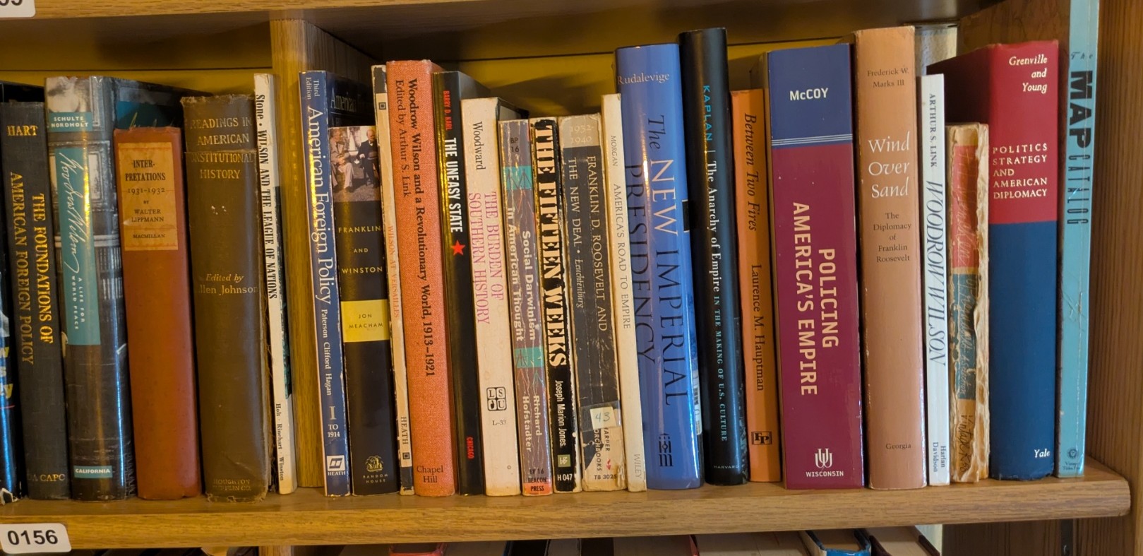 Photograph of Shelf 156; books are listed in top-to-bottom order alongside the photograph.