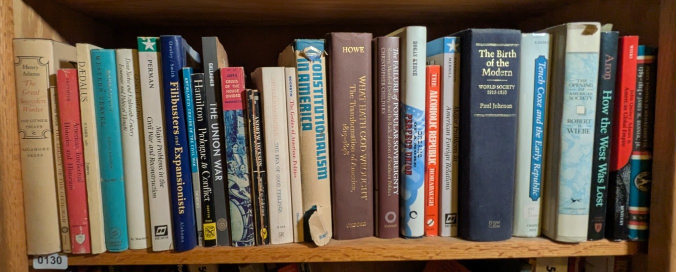 Photograph of Shelf 130; books are listed in top-to-bottom order alongside the photograph.