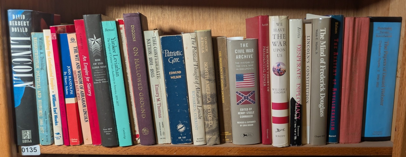 Photograph of Shelf 135; books are listed in top-to-bottom order alongside the photograph.
