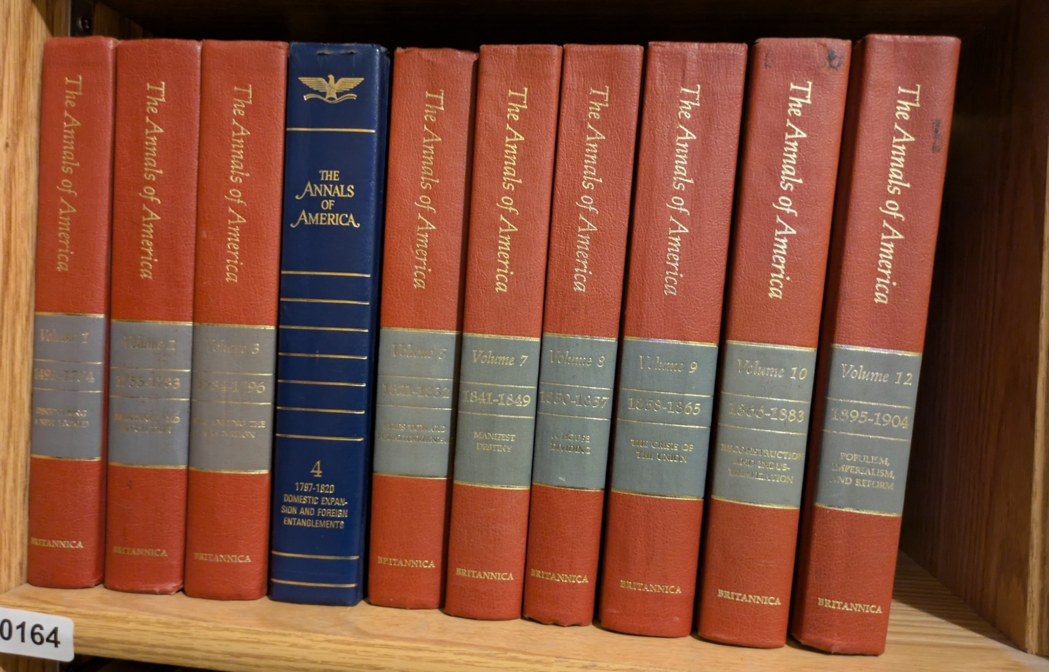 Photograph of Shelf 164; books are listed in chronological order below the photograph.
